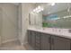 Bathroom with a double sink vanity, neutral color palette, and natural lighting at 2330 E Lieber Pl, Phoenix, AZ 85024