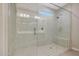 Large walk-in shower with a glass door, rain shower head, and a built-in bench at 2330 E Lieber Pl, Phoenix, AZ 85024