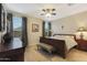 Comfortable bedroom with a wood-look tile floor and a large window at 2330 E Lieber Pl, Phoenix, AZ 85024
