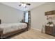 Cozy bedroom with a patterned quilt, decorative accents, and a ceiling fan for a comfortable, relaxing space at 2330 E Lieber Pl, Phoenix, AZ 85024