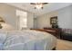 Comfortable bedroom with a wood-look tile floor and view of the ensuite bathroom at 2330 E Lieber Pl, Phoenix, AZ 85024