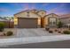 Attractive single-story house showcasing a two-car garage, desert landscaping, and a paved driveway at 2330 E Lieber Pl, Phoenix, AZ 85024