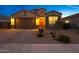 Charming home with a two-car garage, orange front door, and well-maintained landscaping with curb appeal at dusk at 2330 E Lieber Pl, Phoenix, AZ 85024