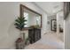 Spacious hallway featuring neutral tones, an ornate mirror, and decorative accents for an inviting ambiance at 2330 E Lieber Pl, Phoenix, AZ 85024