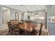 Open-concept kitchen and dining area features modern appliances, tile backsplash, and a large wood table at 2330 E Lieber Pl, Phoenix, AZ 85024