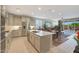 Bright, open kitchen featuring a large island, stainless steel appliances, and a seamless flow to the living area at 2330 E Lieber Pl, Phoenix, AZ 85024