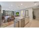 Open-concept kitchen and living area with granite countertops, stainless steel appliances, and ample dining space at 2330 E Lieber Pl, Phoenix, AZ 85024
