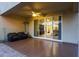 Covered patio featuring comfortable seating, ceiling fan, and sliding glass doors leading to the interior of the home at 2330 E Lieber Pl, Phoenix, AZ 85024