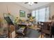 Bright studio space with ample natural light, art supplies, and functional furniture for creative projects at 2330 E Lieber Pl, Phoenix, AZ 85024