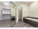 Bathroom view showcasing a tub, tile flooring, and a mirrored closet at 2551 E Buena Vista Pl, Chandler, AZ 85249