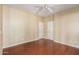 Bedroom with a ceiling fan, wood floors, and two white doors at 2551 E Buena Vista Pl, Chandler, AZ 85249