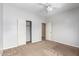 Carpeted bedroom with a ceiling fan, white walls, and closet at 2551 E Buena Vista Pl, Chandler, AZ 85249