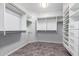 Walk-in closet featuring custom shelving and tile flooring at 2551 E Buena Vista Pl, Chandler, AZ 85249