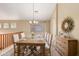 Elegant dining area with a rustic wooden table, stylish chairs, and tasteful decor, perfect for gatherings at 2551 E Buena Vista Pl, Chandler, AZ 85249