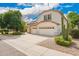 Two-story home with a three car garage, desert landscaping, and a tall cactus at 2551 E Buena Vista Pl, Chandler, AZ 85249