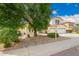 Two-story home with a three car garage, mature landscaping, and desert landscaping at 2551 E Buena Vista Pl, Chandler, AZ 85249