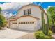Two-story home with a three car garage, desert landscaping, and a tall cactus at 2551 E Buena Vista Pl, Chandler, AZ 85249