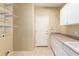 Functional laundry room with storage shelves, cabinets and sink at 2551 E Buena Vista Pl, Chandler, AZ 85249