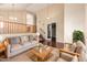 Bright living room with wooden floors, large windows, vaulted ceiling, and comfortable seating area, creating an inviting space at 2551 E Buena Vista Pl, Chandler, AZ 85249