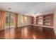 Cozy living room features hardwood floors, built-in shelves, and seamless access to the backyard at 2551 E Buena Vista Pl, Chandler, AZ 85249