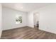 Sunlit bedroom featuring hardwood floors, a window with blinds, and ensuite bathroom entry at 2650 W Union Hills Dr # 123, Phoenix, AZ 85027