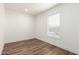 Bright bedroom featuring wood floors, a large window, and ample natural light at 2650 W Union Hills Dr # 123, Phoenix, AZ 85027