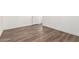 Bedroom showcasing stylish wood flooring, white trim, and minimalist design elements at 2650 W Union Hills Dr # 123, Phoenix, AZ 85027
