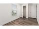 Comfortable bedroom with wood floors, large window, and an open closet space at 2650 W Union Hills Dr # 123, Phoenix, AZ 85027