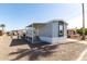 Charming mobile home featuring a covered entrance, neutral paint scheme, and low-maintenance gravel landscaping at 2650 W Union Hills Dr # 123, Phoenix, AZ 85027
