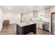 Modern open-concept kitchen and living room featuring stainless steel appliances and wood flooring throughout at 2650 W Union Hills Dr # 123, Phoenix, AZ 85027
