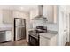 Bright kitchen with stainless steel appliances, light countertops, wood floors, and an undermount sink at 2650 W Union Hills Dr # 123, Phoenix, AZ 85027