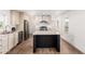 Bright kitchen with stainless steel appliances, modern wood flooring, and an eat-in kitchen island at 2650 W Union Hills Dr # 123, Phoenix, AZ 85027