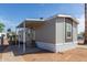 Charming home featuring a covered porch, gray siding, and landscaped surroundings on a sunny day at 2650 W Union Hills Dr # 91, Phoenix, AZ 85027