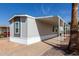 Charming home featuring a covered porch and gray siding, surrounded by desert landscaping at 2650 W Union Hills Dr # 91, Phoenix, AZ 85027