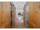 Elegant bathroom entryway with natural wood sliding doors leading to a soaking tub at 27171 N 73Rd St, Scottsdale, AZ 85266