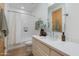 Cozy bathroom featuring a single vanity, a bathtub with shower, and a wood-framed mirror at 27171 N 73Rd St, Scottsdale, AZ 85266