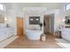 Bright bathroom with a soaking tub, dual sinks, and a separate shower at 27171 N 73Rd St, Scottsdale, AZ 85266