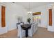 Elegant dining room with a large table, chandelier, and natural light streaming through the windows at 27171 N 73Rd St, Scottsdale, AZ 85266