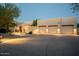 Well-maintained exterior showing a spacious driveway and multiple car garage with exterior lighting at 27171 N 73Rd St, Scottsdale, AZ 85266