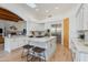 Bright kitchen with white cabinetry, center island, stainless steel appliances, and an adjacent living space at 27171 N 73Rd St, Scottsdale, AZ 85266