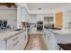 Modern kitchen with white cabinets, stainless steel appliances, and a large island with seating at 27171 N 73Rd St, Scottsdale, AZ 85266