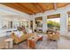 Spacious living area with wood beam ceiling, comfortable seating, and views of the outdoor space at 27171 N 73Rd St, Scottsdale, AZ 85266