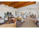 Expansive living room with wood beam ceiling, open layout, and seamless flow to the kitchen and dining areas at 27171 N 73Rd St, Scottsdale, AZ 85266