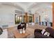 Spacious living room with wood flooring, arched columns, and a seamless transition to the dining area at 27171 N 73Rd St, Scottsdale, AZ 85266
