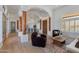 Open-concept living room featuring wood floors, beamed columns, and abundant natural light at 27171 N 73Rd St, Scottsdale, AZ 85266