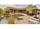 Backyard pool featuring a rock waterfall, desert landscaping, and poolside lounge area at 27171 N 73Rd St, Scottsdale, AZ 85266