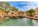 Inviting pool features a rock waterfall and lush desert foliage at 27171 N 73Rd St, Scottsdale, AZ 85266
