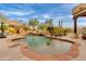 Lush pool area with a rock waterfall, and palm trees at 27171 N 73Rd St, Scottsdale, AZ 85266