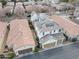 Aerial view of home with solar panels on roof in a neighborhood with tile roofs and manicured landscaping at 3438 E Betsy Ln, Gilbert, AZ 85296