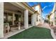 Charming covered back patio with artificial turf, perfect for outdoor entertaining and relaxation at 3438 E Betsy Ln, Gilbert, AZ 85296